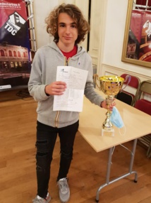 Marc'Andria tient dans ses mains la coupe du vainqueur et aussi l'attestation de sa 3e norme de GM